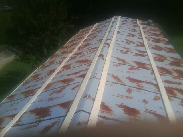 Rusted metal roof panels with new wood purlins before replacement — Storm Damage Roof Repair in Verden by Roofing Brothers