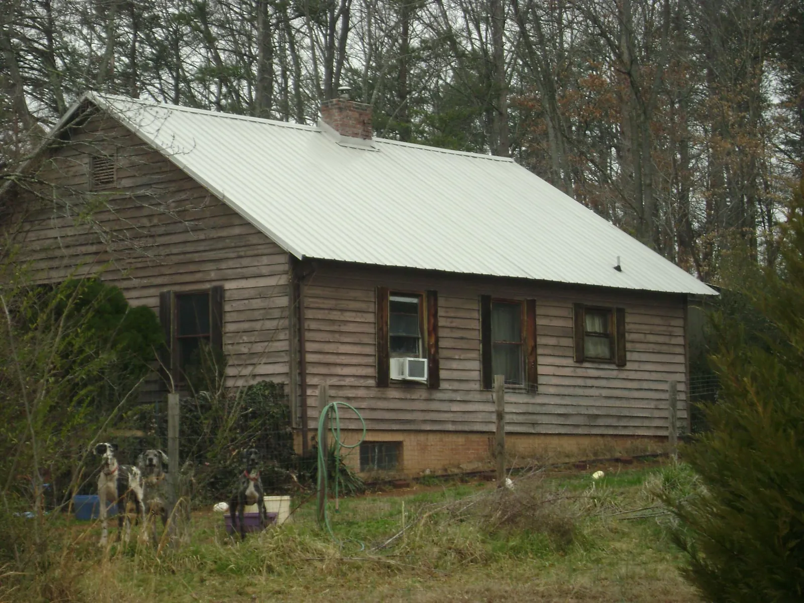 White metal roof on an old wood sided farmhouse, from a Metal Roof Installation job in Verden